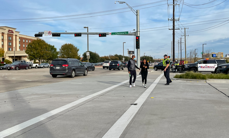 Police officer helping the pedestrian to cross the road