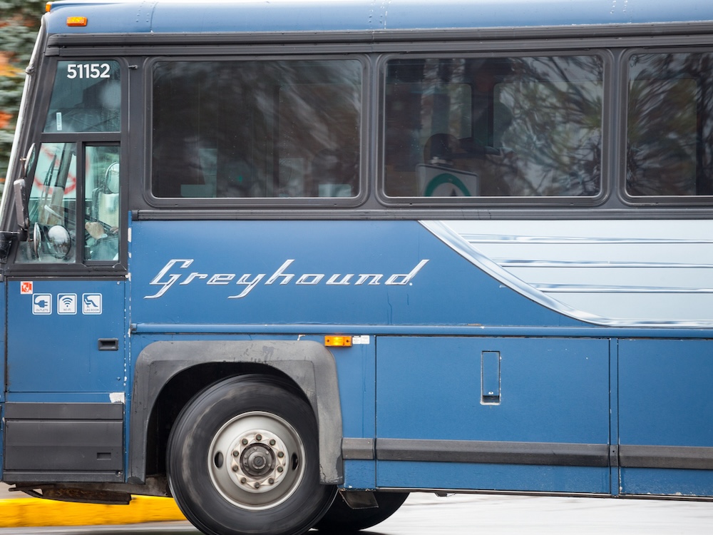 A Greyhound bus on the road.