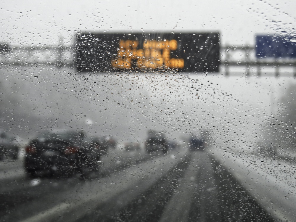 hazardous weather condition on the road seen through windshield