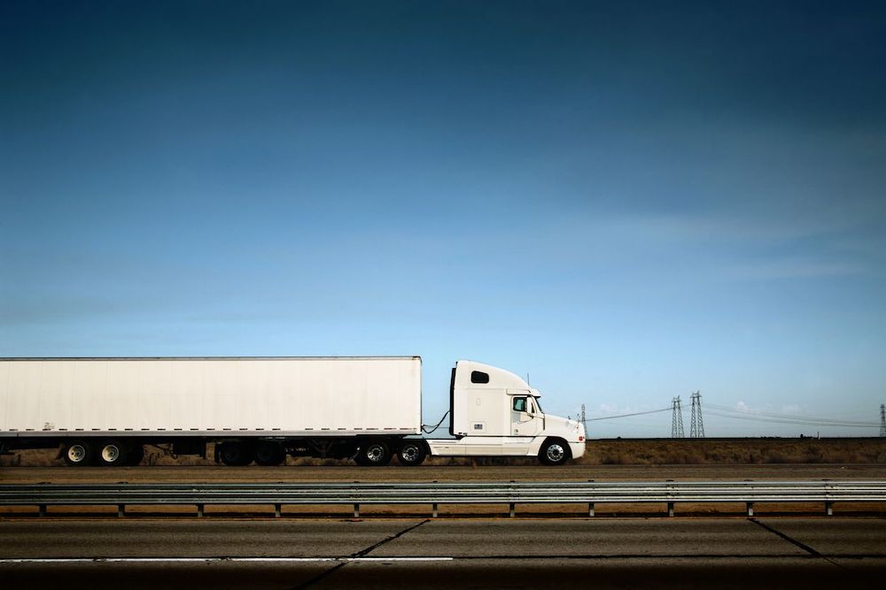 An 18-wheeler on a remote stretch of highway.