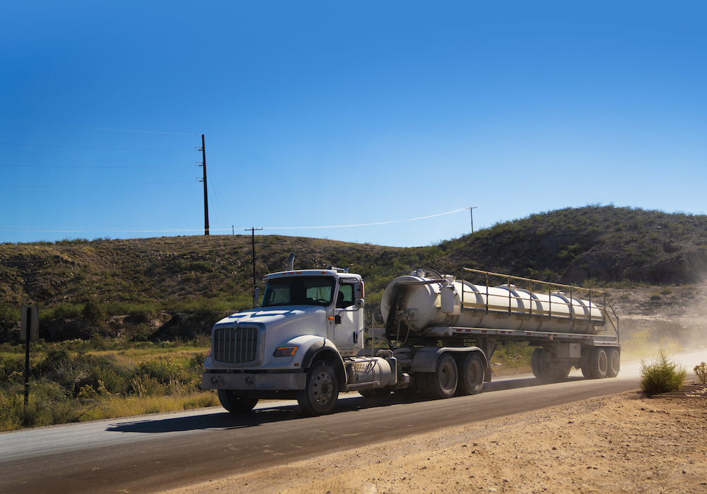 Oilfield truck driving in a dirt road in the Permian Basin. Undefeated Oilfield Truck Accident Attorneys